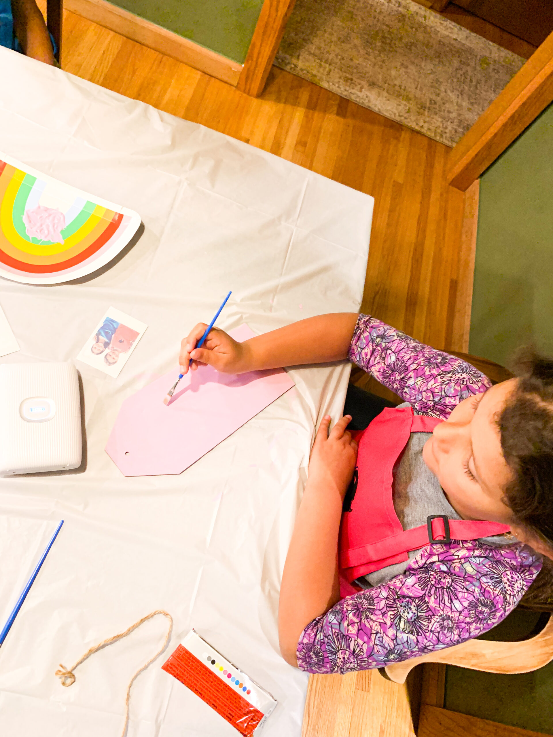 child painting a wooden photo frame at a craft party