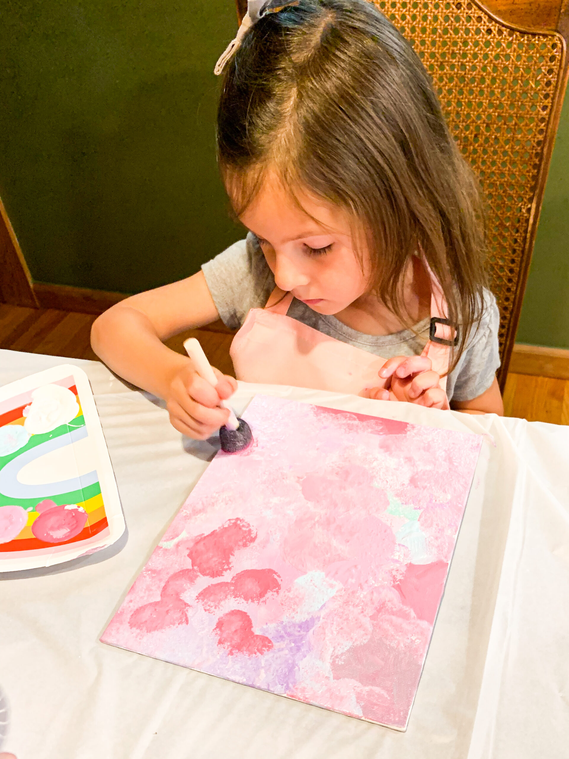 child painting a hidden image image canvas at a craft party