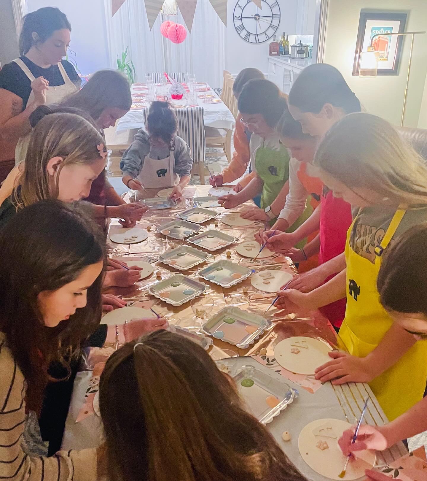 child painting a wooden photo frame at a craft party