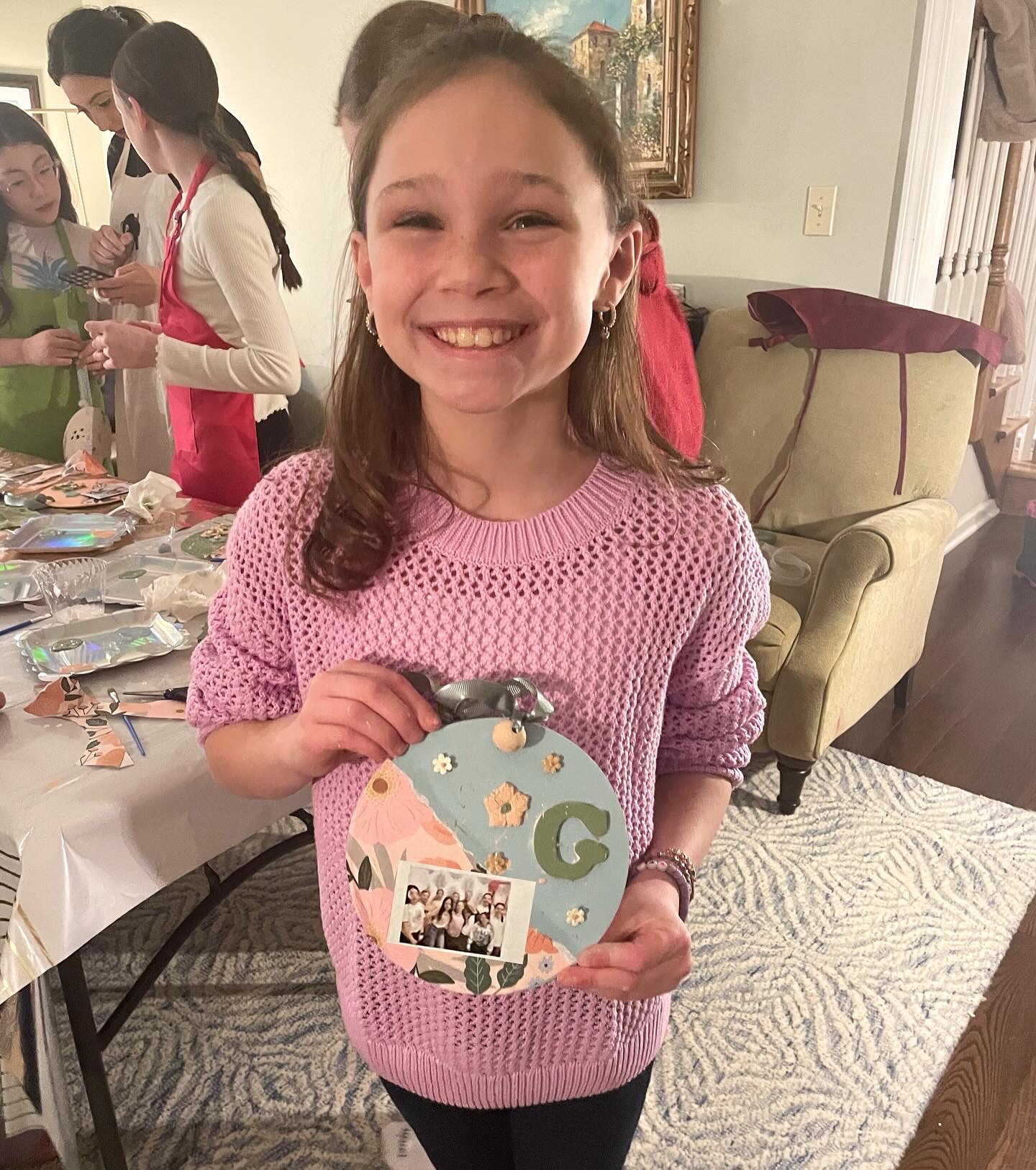 child painting a wooden photo frame at a craft party