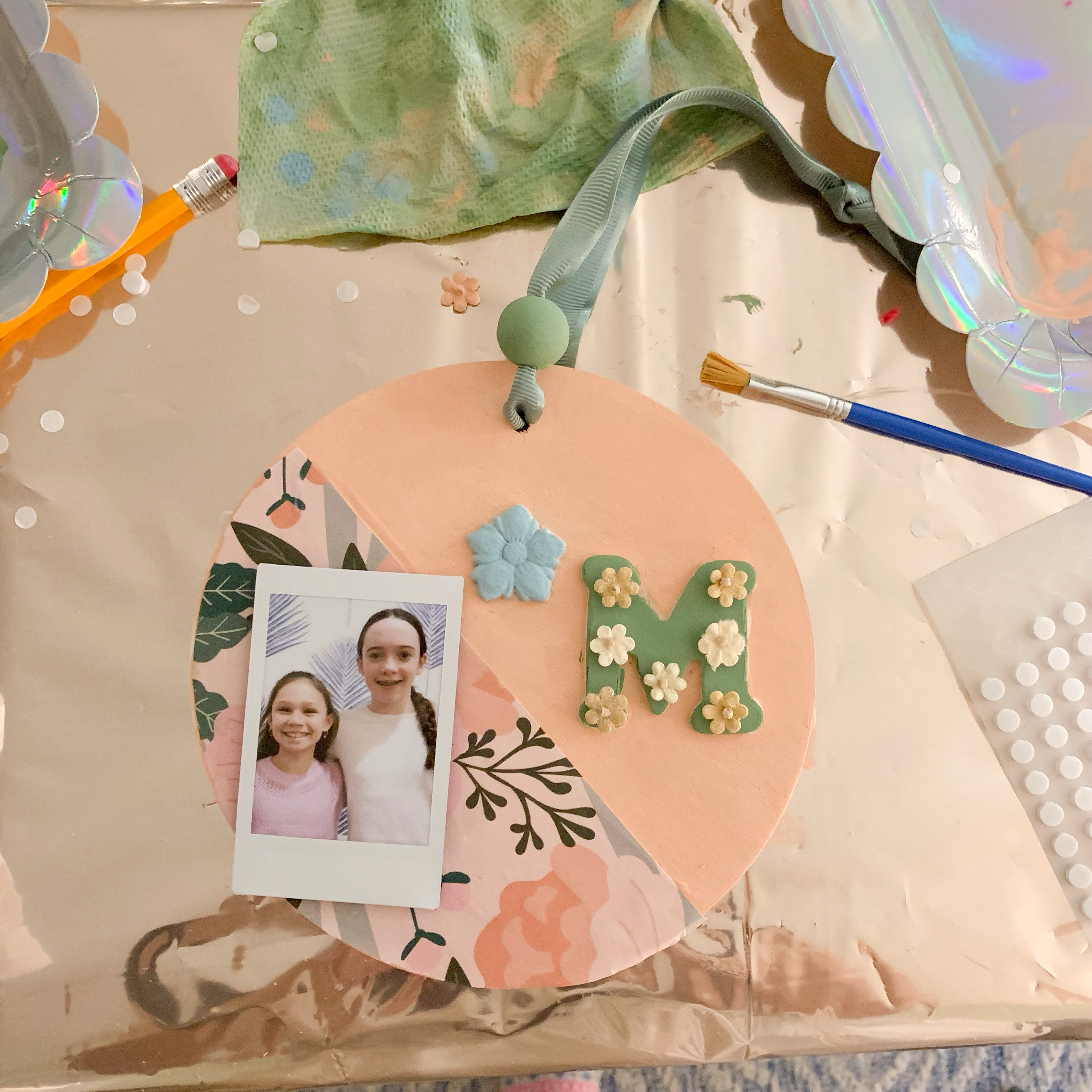 child painting a wooden photo frame at a craft party